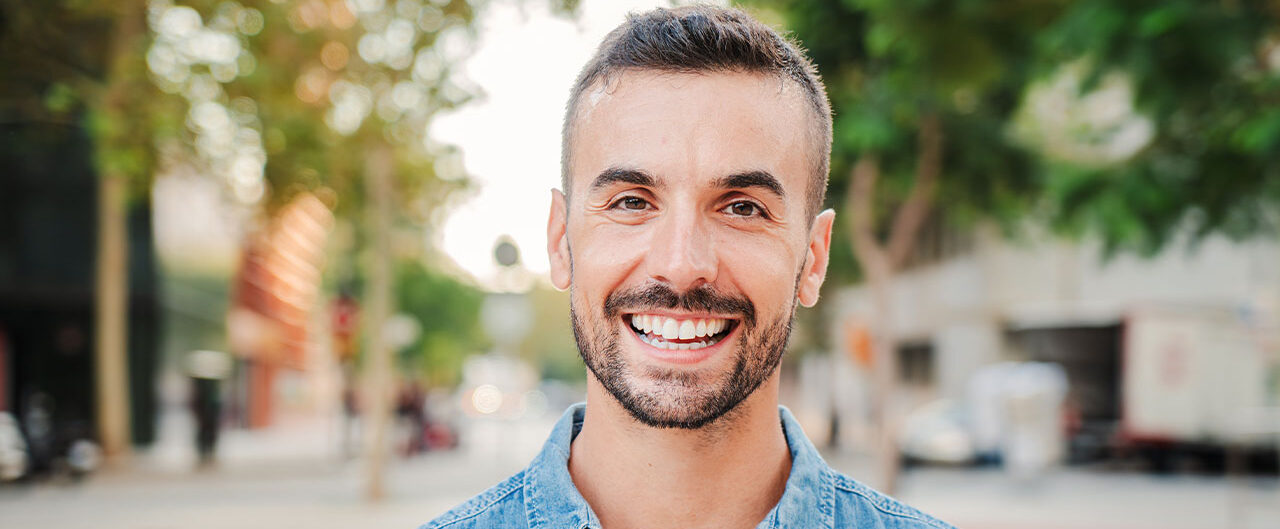 a man smiling at the camera