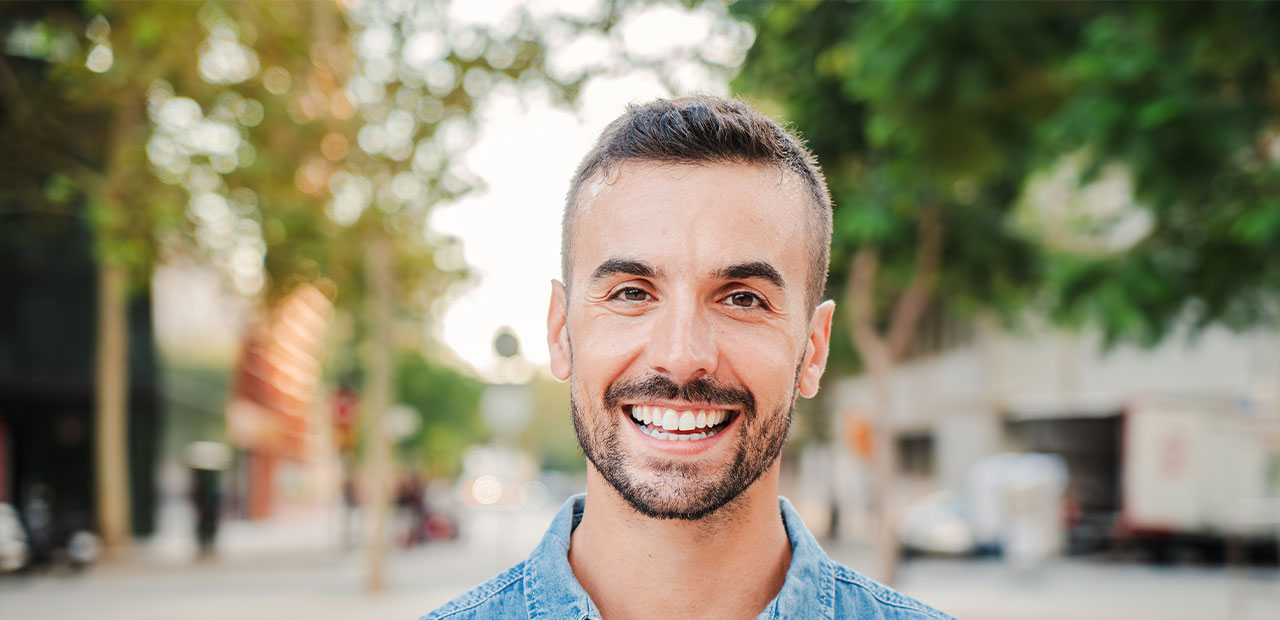 full-mouth-restorations-header-image a man smiling at the camera
